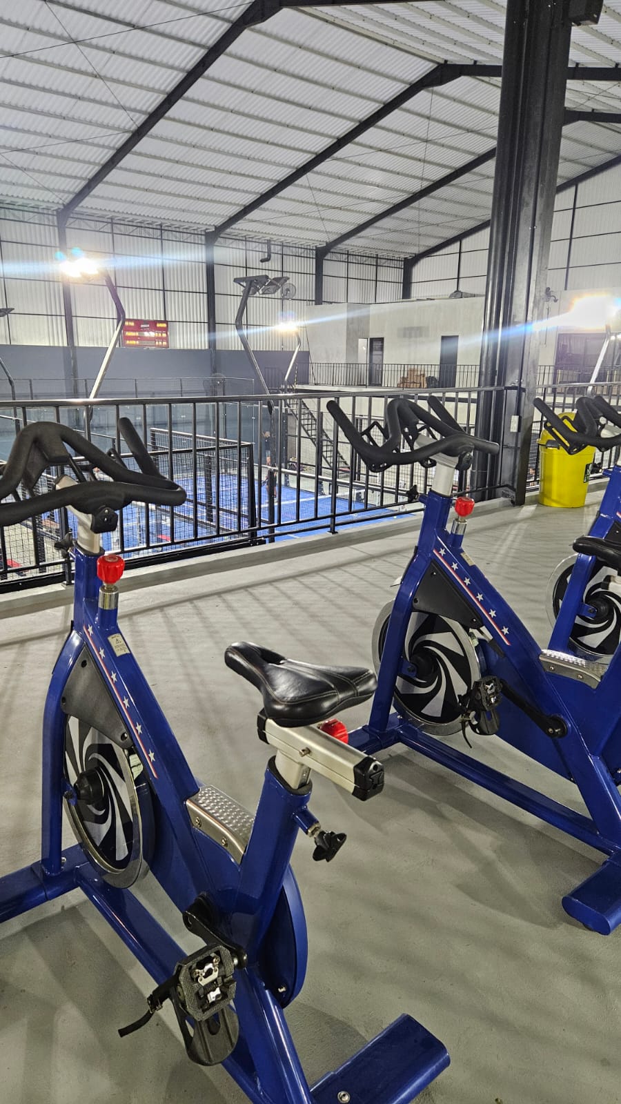 Second floor warm-up bikes overlooking courts